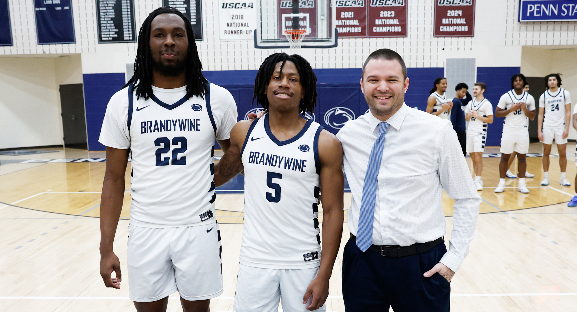 two basketball players with coach