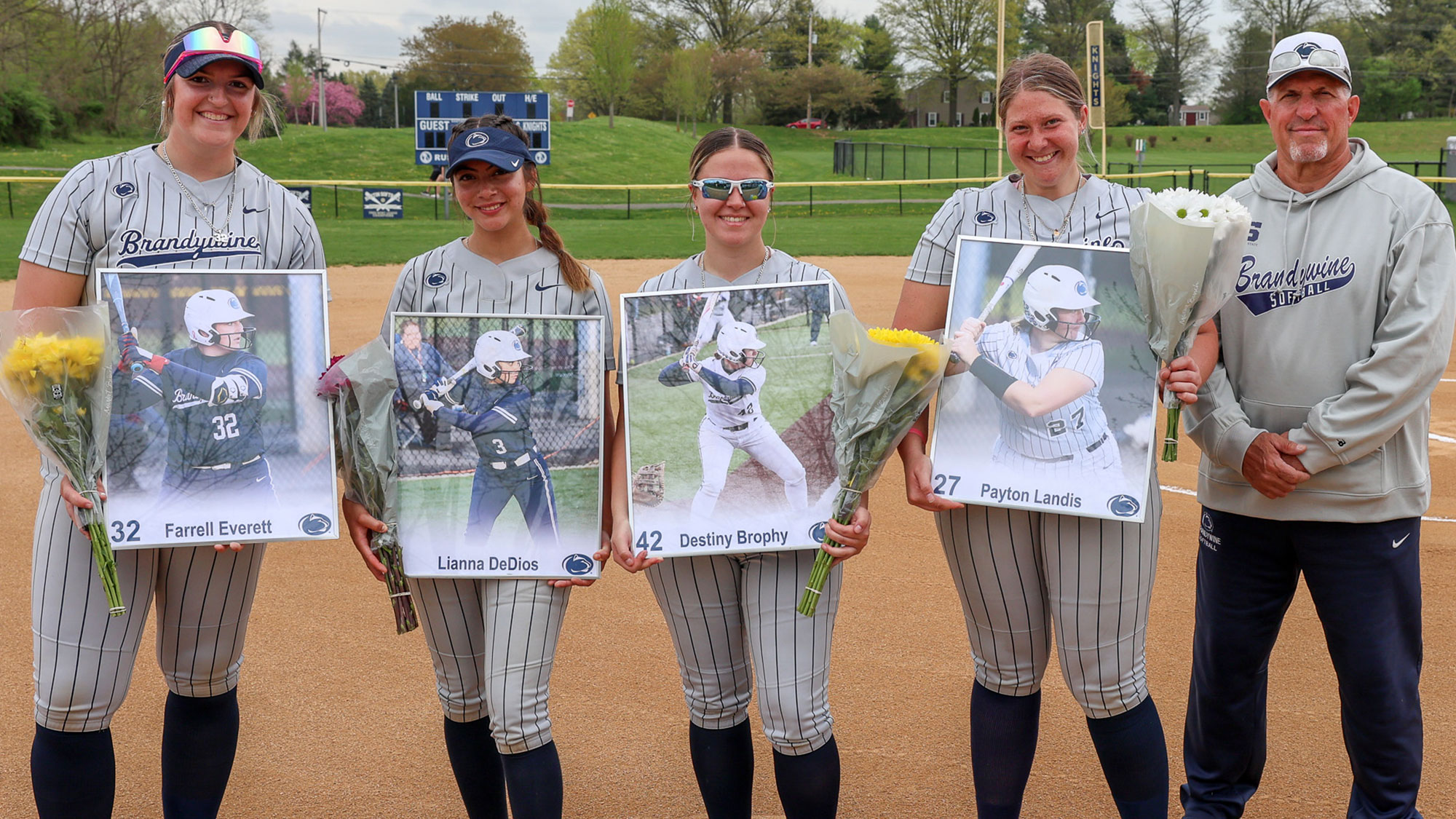 Seniors Farrell Everett, Lianna DeDios, Destiny Brophy and Payton Landis with head coach Mark Caserta