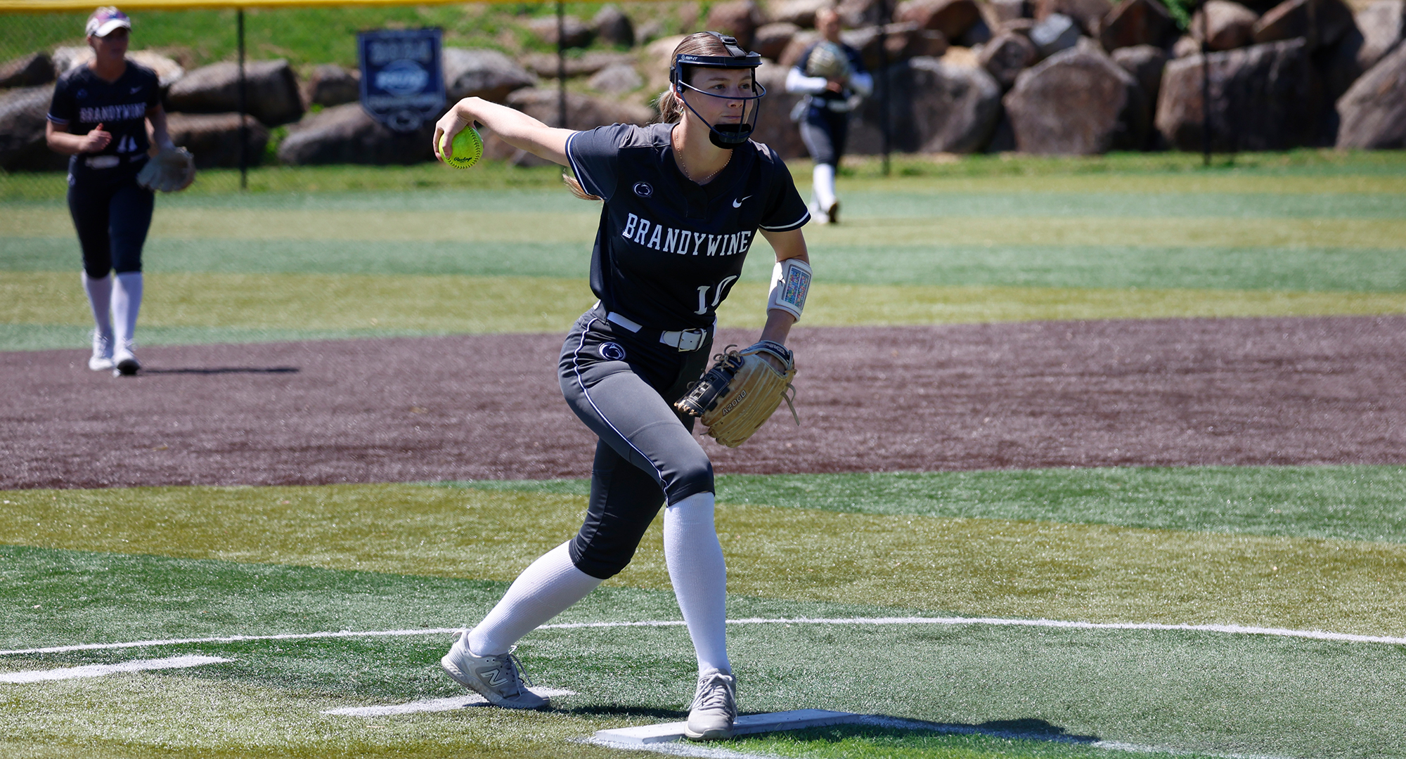 softball pitcher mid-wind up