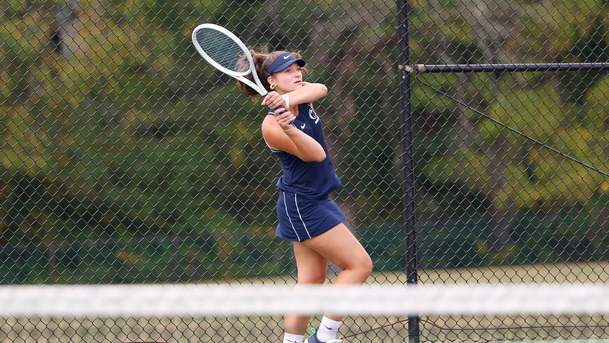 women's tennis player finishes her swing